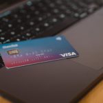 Blue and white visa card on a laptop