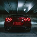 Tail lights of a sporty red car driving away